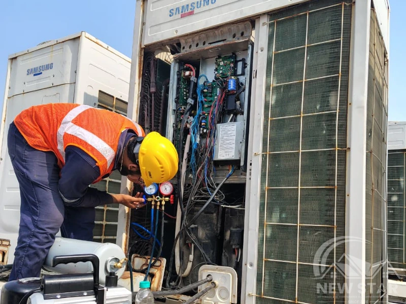 AC repair in Trivandrum by New Star AC Solutions technician checking gas pressure on outdoor unit